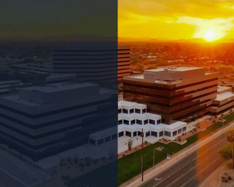 A cityscape image divided in half, showing the left side in dull, dark colors and the right side in bright, vivid colors with a sunset over office buildings and a main road.