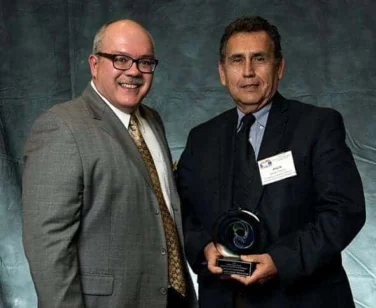 Two men with an award at the SHRM Celebrating Innovation event