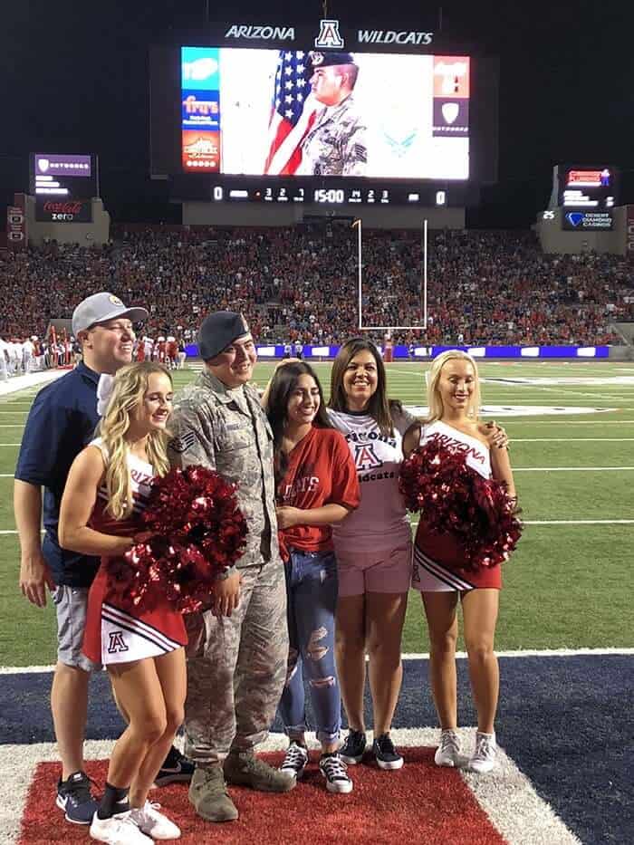 Service member honored with cheerleaders on the field at an Arizona Wildcats game