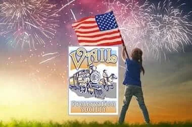 Girl waving an American flag under fireworks with the Vail Preservation Society logo