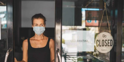 Store Owner in medical mask closed restaurant for quarantine