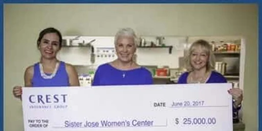 Three women holding a $25,000 Crest Insurance Group check made out to Sister Jose Women's Center