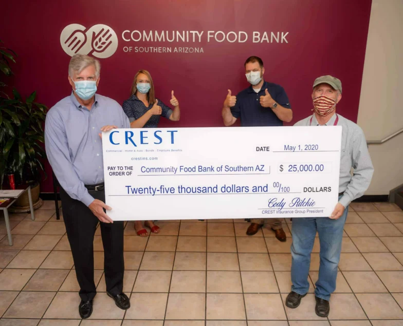 Crest Insurance team presenting a $25,000 check to the Community Food Bank of Southern Arizona