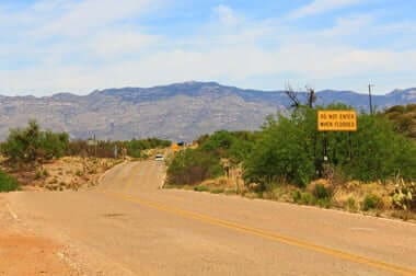 Desert road leading toward mountains