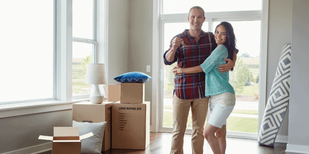 Two people hugging in their new home