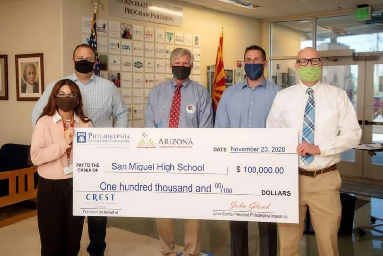 Crest Insurance and Philadelphia Insurance presenting a $100,000 check to San Miguel High School