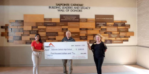 Crest Insurance and CopperPoint presenting a $5,000 check at Salpointe Catholic High School