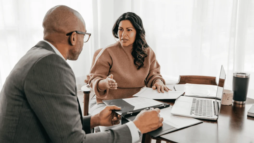 Insurance advisor meeting with a client at a desk