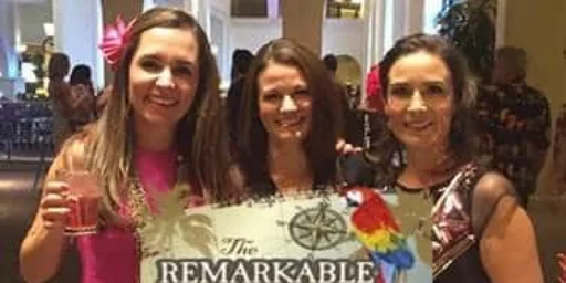 Three women holding a Remarkable Celebration sign