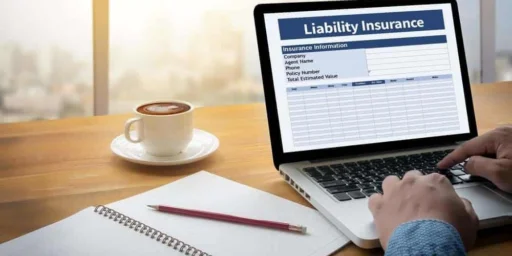 Laptop showing a liability insurance form beside a coffee cup and notebook
