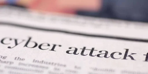Newspaper headline reading cyber attack