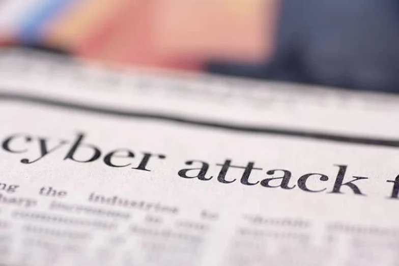 Newspaper headline reading cyber attack