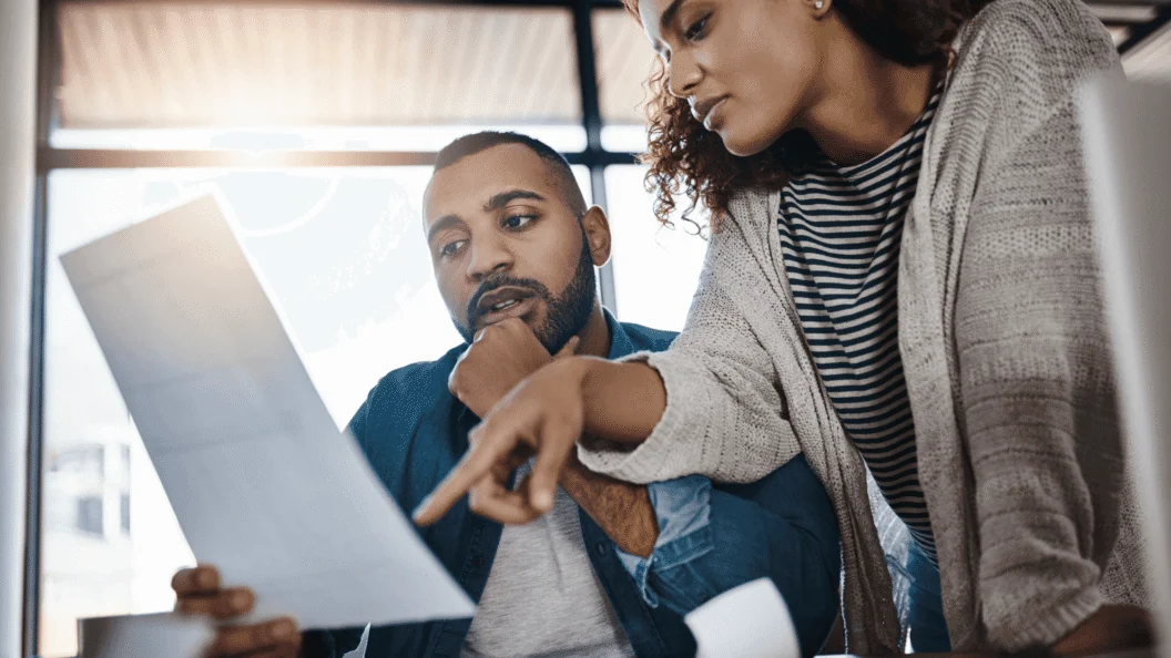 Woman and man looking at laptop